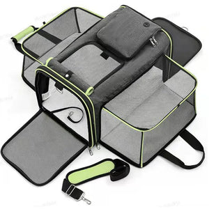 Pet carrier with clear sides, gray interior, and black straps on a white background