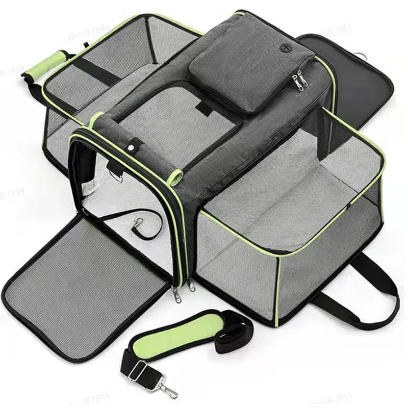 Pet carrier with clear sides, gray interior, and black straps on a white background