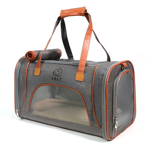 Gray pet carrier with orange accents and a visible brand logo on a white background