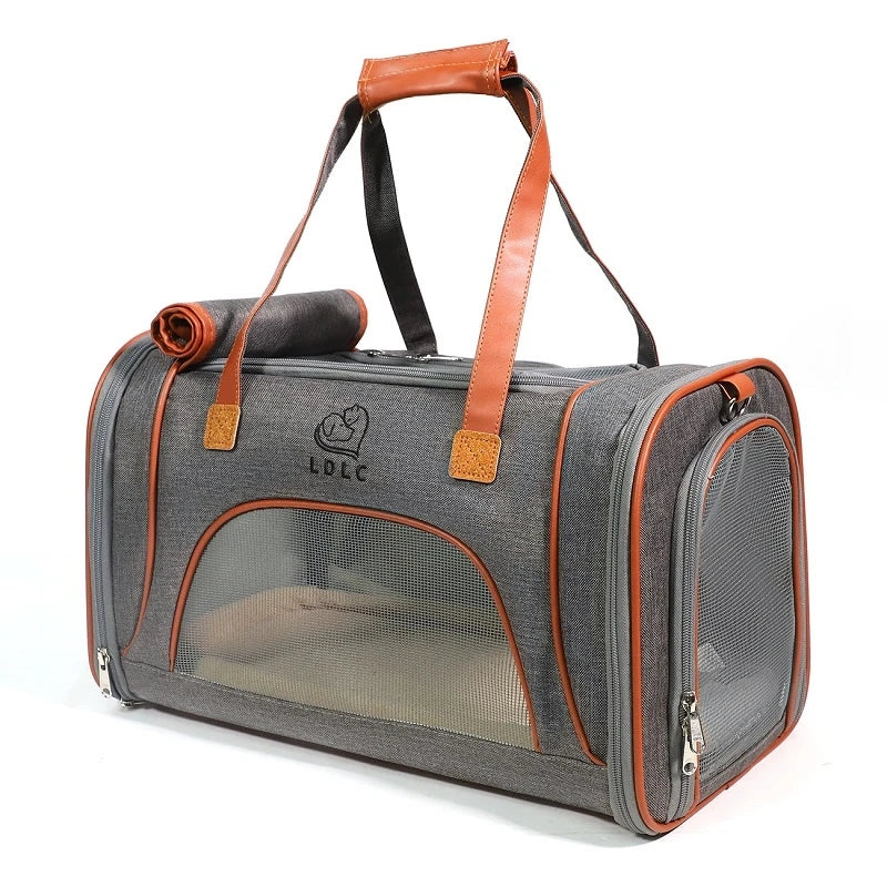 Gray pet carrier with orange accents and a visible brand logo on a white background